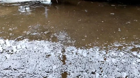 Raindrops and shallow puddles on the cement floor Stock Footage 304431990
