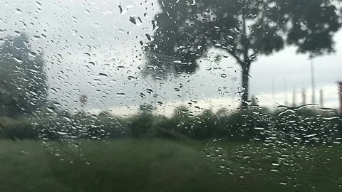 Raindrops are streaming down the car´s windshield Stock Footage 276557995