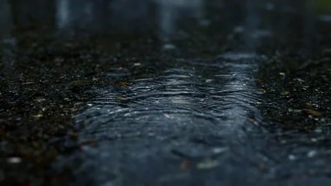 Raindrops on asphalt pavement puddle Stock Footage 147571149