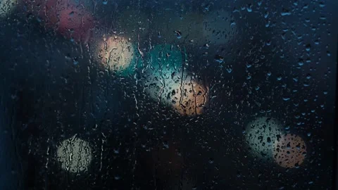 Raindrops background of a blurred night city with cars. Stock Footage 270581503