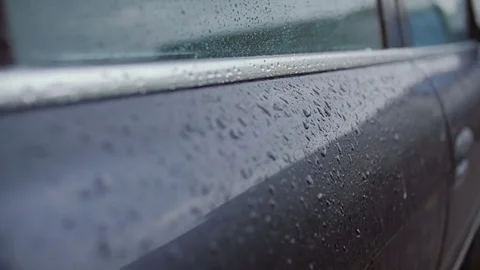 Raindrops beat against the car body. Stock Footage 78699485