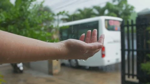 Raindrops beat the woman's hand Stock Footage 73589658