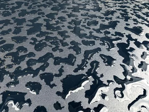 Raindrops on the black table surface that forms some abstract conceptual back Stock Photos