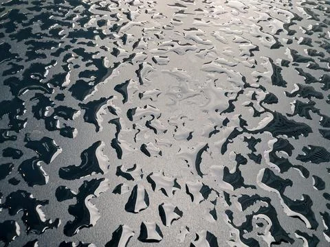 Raindrops on the black table surface that forms some abstract conceptual back Stock Photos