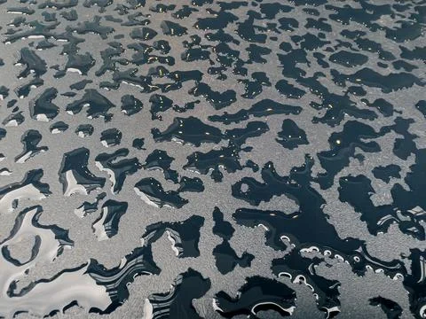 Raindrops on the black table surface that forms some abstract conceptual back Stock-Fotos
