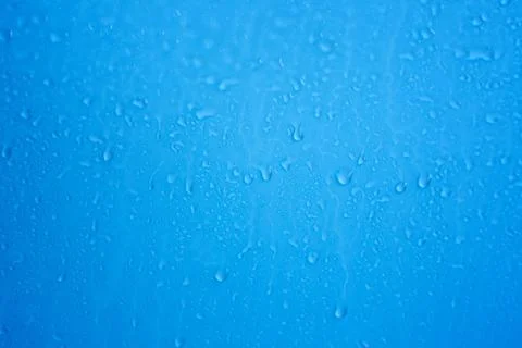 Raindrops on blue background Stock Photos