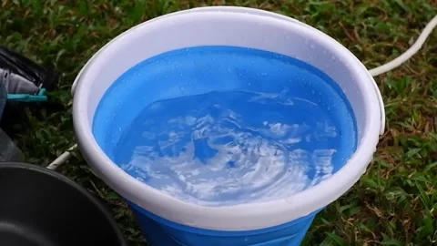Raindrops in blue plastic bucket, rain at the camping site Stock-Footage 308727268