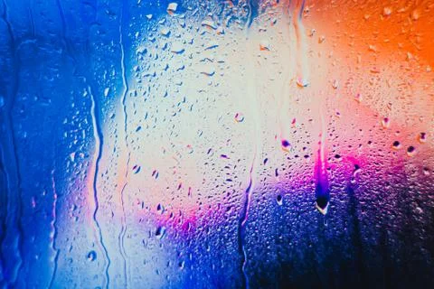 Raindrops on a blurred multicolored background Stock Photos
