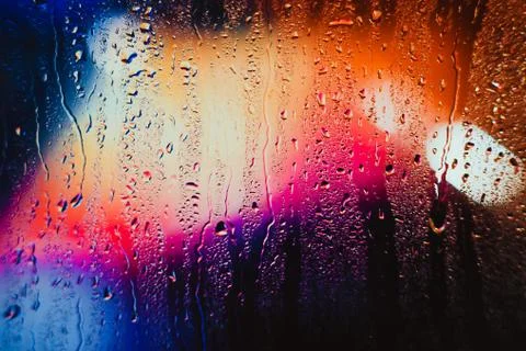 Raindrops on a blurred multicolored background Stock Photos