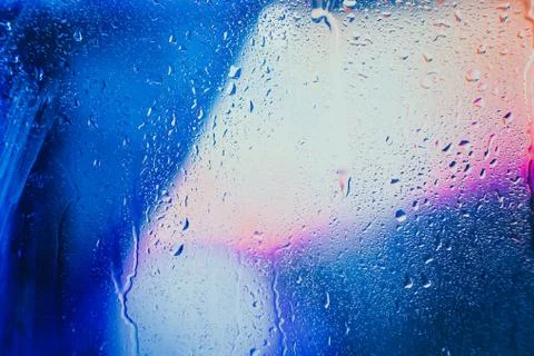 Raindrops on a blurred multicolored background Stock Photos