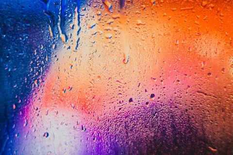 Raindrops on a blurred multicolored background Stock Photos