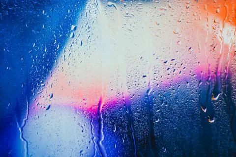 Raindrops on a blurred multicolored background Stock Photos