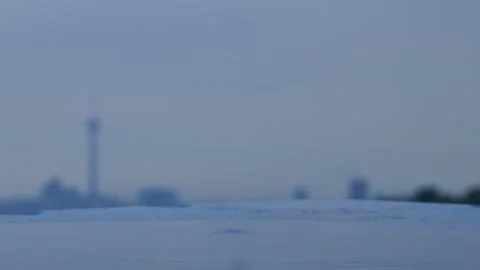 Raindrops on blurred surface with Milad Tower skyline in the distance Stock Footage 317836993