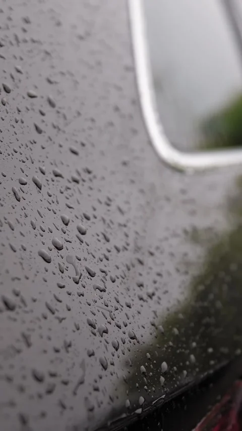 Raindrops on car. rain. raining. raindrops fall to surface of modern black car Stock Footage 316889041
