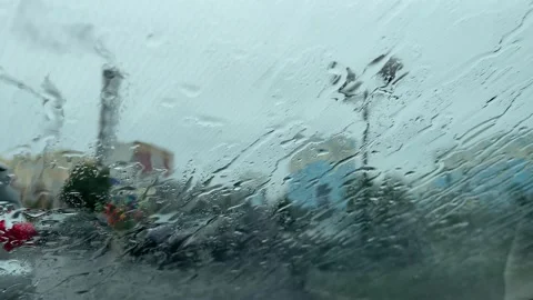 Raindrops on the car window are brushed away by the wipers Stock Footage 162326844