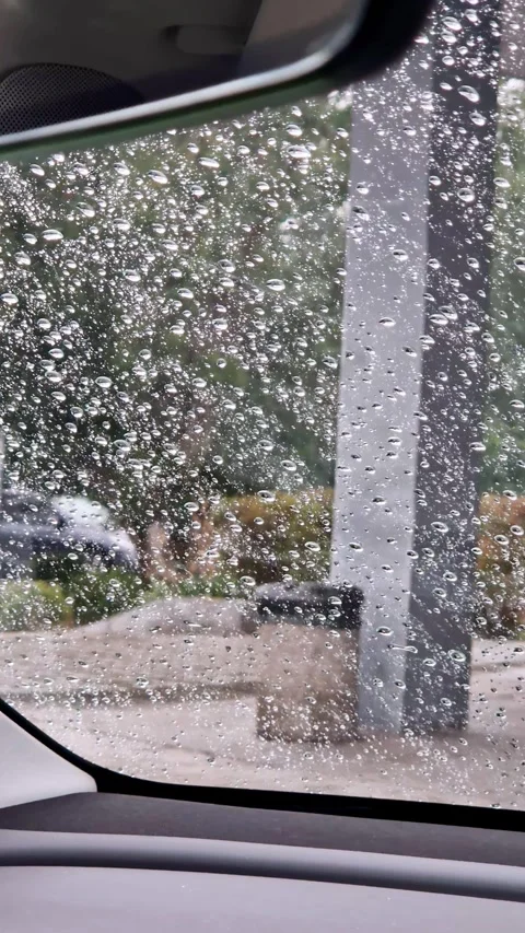 Raindrops on Car Window Interior View with Blurred Background Stock Footage 325217983