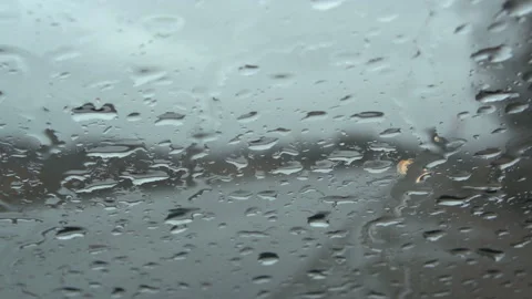 Raindrops on car window in rainy day with blurred cars traffic on background Stock-Footage 127086676