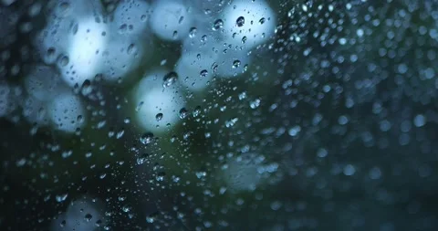 Raindrops On Car Window With Soft Green Bokeh... Stock Footage 332075558