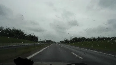 Raindrops on the car window, transport moves on the highway outside the city. 4K Stock-Footage 114890632