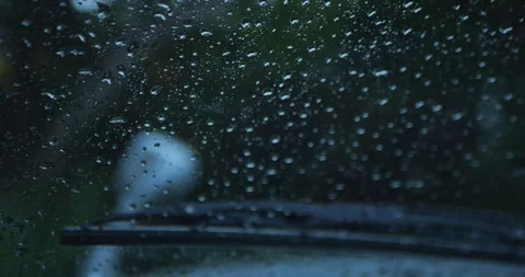Raindrops On Car Windshield With Blurred Road And Trees... Stock Footage 332075480
