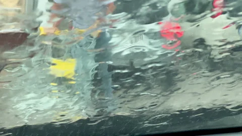 Raindrops On Car Windshield During Heavy Rain In City Traffic Video stock 341401226