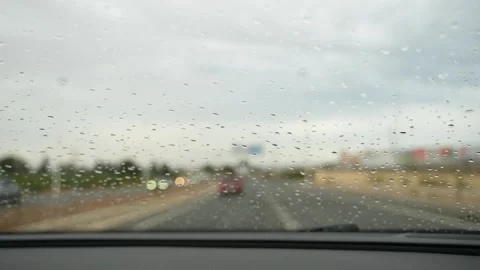 Raindrops on Car Windshield During Rainy Drive Close Up Stock Footage 345986821