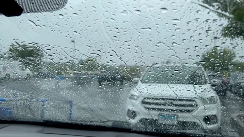 Raindrops on Car Windshield in Outdoor Parking Lot Video stock 345983307