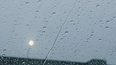 Raindrops on Car Windshield with Water Dripping Down on a Gloomy Day Stock Footage 329485197