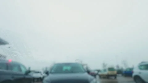 Raindrops on car windshield, wipers cleaning water in rainy weather, France. Stock Footage 328972052