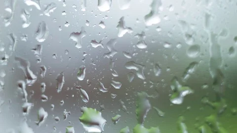 Raindrops cascading down on a window Video stock 78687549