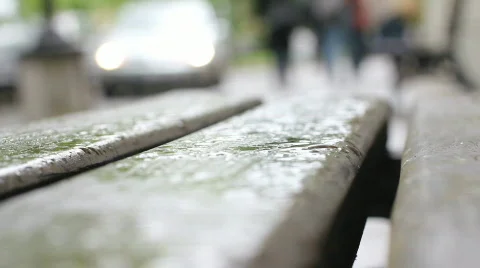 Raindrops on a city bench Stock Footage 742339