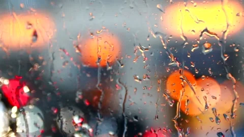 Raindrops in the city on the window . Defocus . Drops on the glass. City lights Stock Footage 141074974