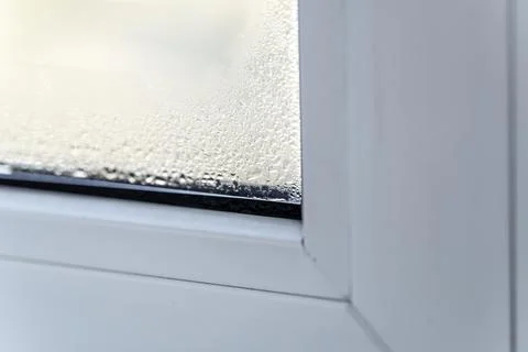 Raindrops clinging to the window pane like tiny, shimmering jewels on a whi.. Stock Photos