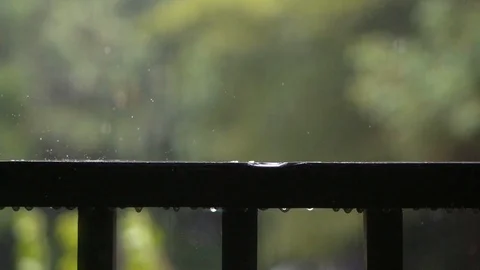 Raindrops close up falling on the balcony with blur background Slow motion Stock Footage 126044776