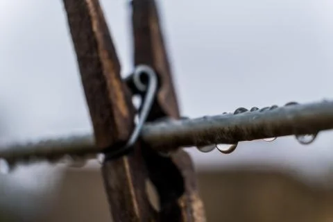 Raindrops on a clothes line isolated with a blurred background Stock Photos