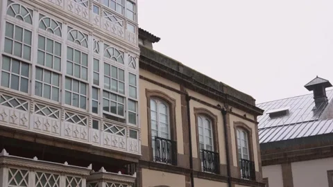 Raindrops in cloudy weather, closed windows of the house and roofs of houses. Stock Footage 237002106