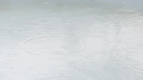 Raindrops creating circular waves on the water surface Stock Footage 160150560