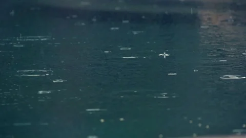 Raindrops on dark blue water in slow motion Stock Footage 101122136
