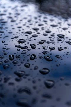 Raindrops on a dark car Stock Photos