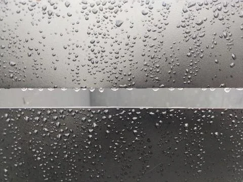 Raindrops on a Dark Metal Surface Stock Photos