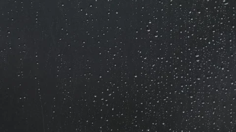 Raindrops On Dark Window Background - 4K Video Stock Footage 340473773