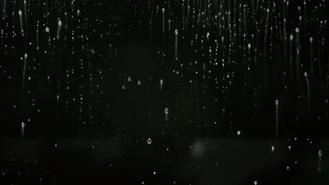 Raindrops on a dark window with water droplets Stock Photos