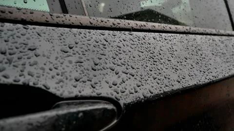 Raindrops on the door of a black car Stock Footage 204991407