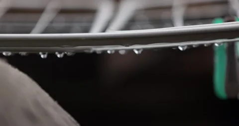 Raindrops drip off the edge. Close-up. Slow motion. Stock Footage 153404829