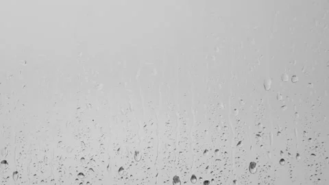 Raindrops dripping and running down the window in the rain. Stock Footage 196172023
