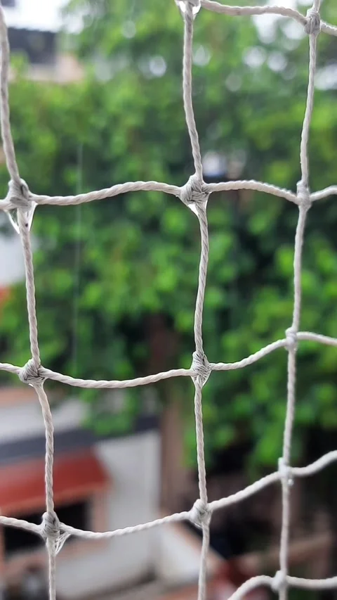 Raindrops Dripping Down Balcony Safety Net During Rainfall Stockbeeldmateriaal 340562799