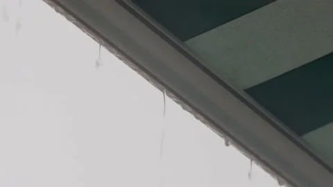 Raindrops dripping from edge of awning Stock Footage 152421681