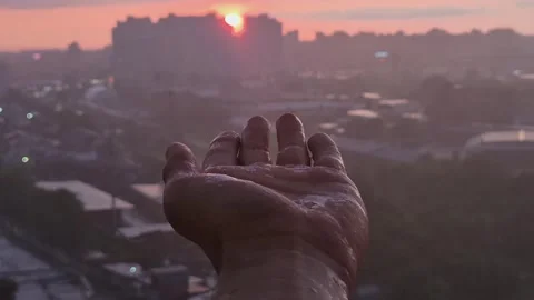 Raindrops dripping on a man's palm at sunset, close-up Stock-Footage 310856537