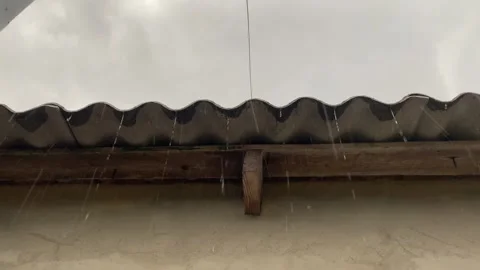 Raindrops dripping from rooftop Stock Footage 313942828