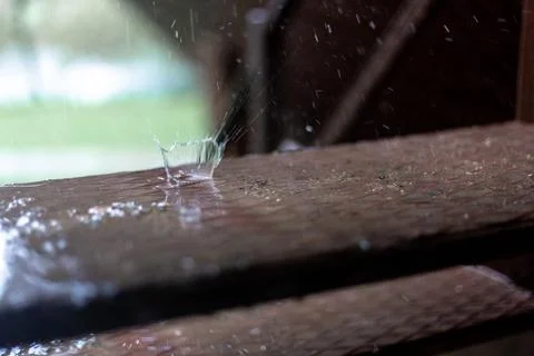 Raindrops dripping on the steps. Brown steps. Stock Photos